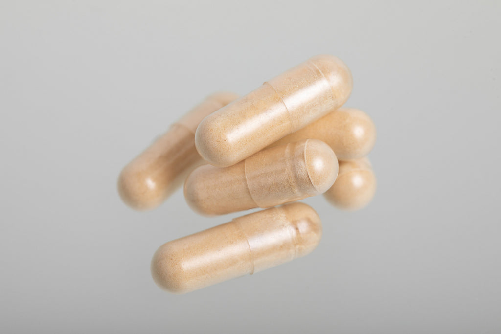 Close-up of Sporelane vegan Tremella extract capsules showing the powder inside clear capsules